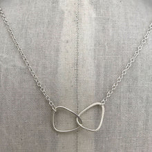 Load image into Gallery viewer, sterling silver interlocking charm on sterling silver chain on display