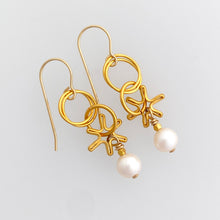 Load image into Gallery viewer, Earrings made with dangling elements of 24kt gold plate over sterling silver circles and freshwater pearls
