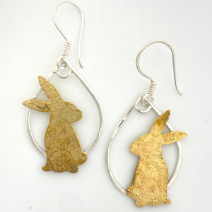 earrings with brass rabbit silhouettes on sterling silver tear drop shaped hoops