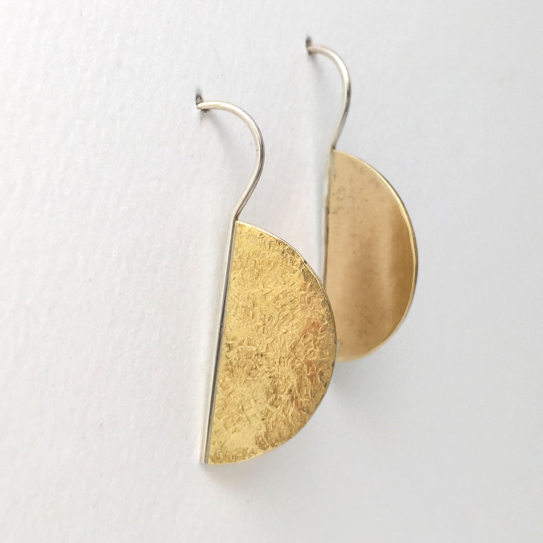 textured semi circle brass earrings  on attached sterling silver ear wire side view