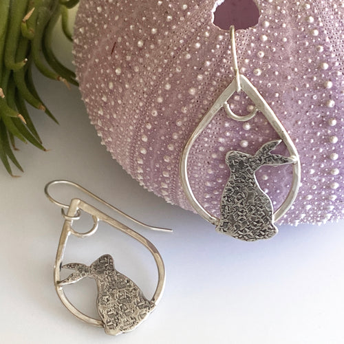 sterling silver earrings with rabbit silhouettes on teardrop hoops