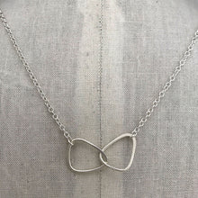 Load image into Gallery viewer, sterling silver interlocking charm on sterling silver chain on display
